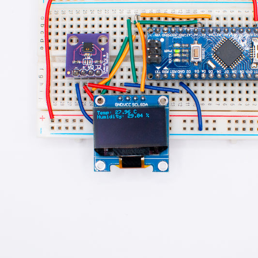 0.96" OLED display, connected to Arduino and temperature sensor module, displaying temperature and humidity