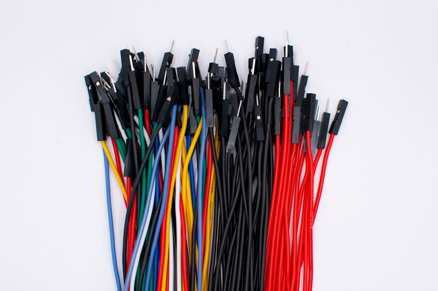 Close-up shot of silicone dupont wires in various colors, with plugs and sockets